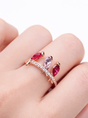 Close-up of Three Birds Sparkle Ring in rose gold with pink stones